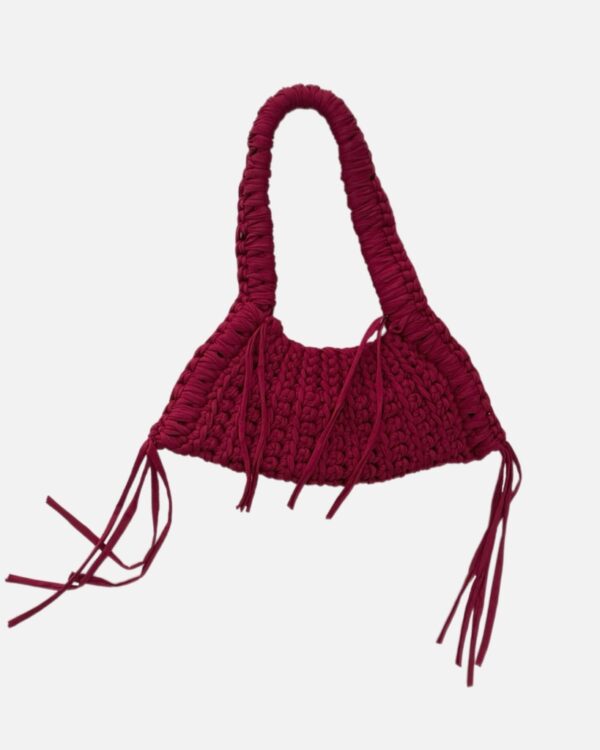 This handcrafted burgundy bag combines style and function with its chunky crochet texture. Made from soft t-shirt yarn, it easily transitions from shoulder to handbag, making it the perfect companion from day to night. Features a stretchy yet sturdy construction that adapts to your needs.
