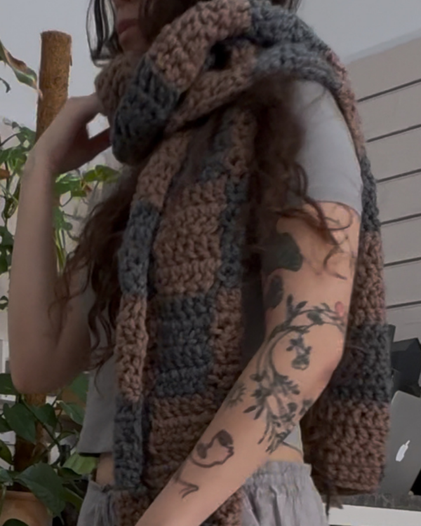 Close-up of a handmade grey and beige checkered crochet scarf by new notion