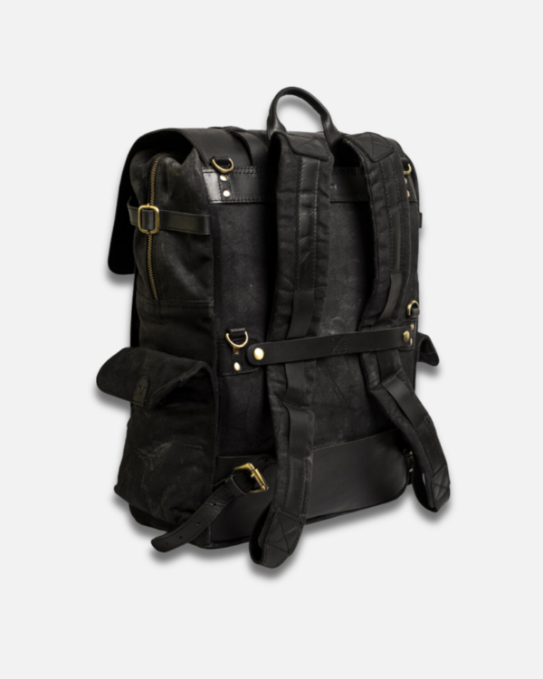 Meet the Rambler: a handcrafted 24L backpack that combines heavy-duty 14oz waxed canvas with premium crunch leather. Built for both daily commutes and motorcycle adventures, it features four quick-access pockets, water-resistant construction with double-waxed canvas, and a protective rain cover. The reinforced back panel ensures comfort whether you're wearing it or mounting it on your motorcycle. Perfect for everything from everyday carry to weekend getaways.