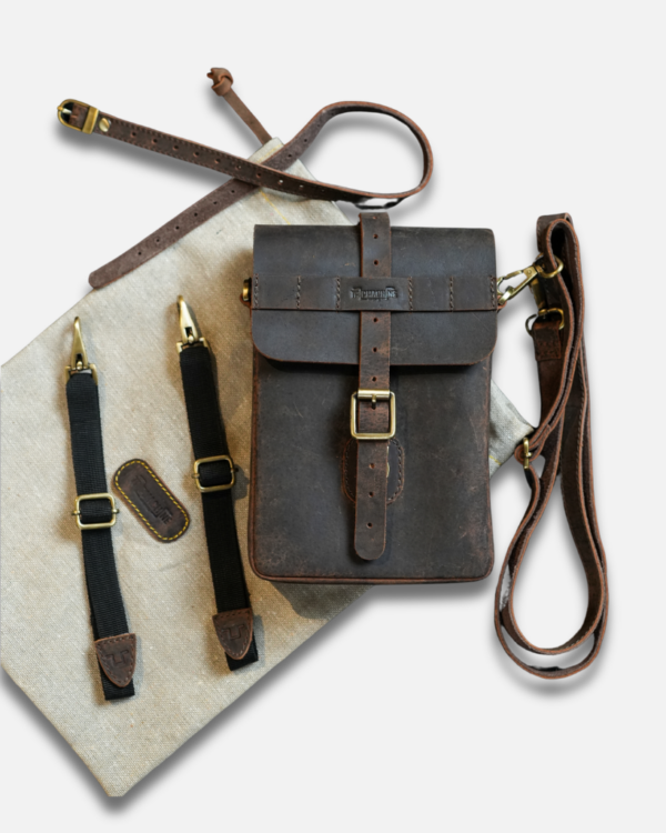Premium leather sling bag with quick-release mounting (motorcycle compatible), one-click opening, and included rain cover. Handcrafted and built to last, developing a unique patina over time. Perfect for everyday carry and more.