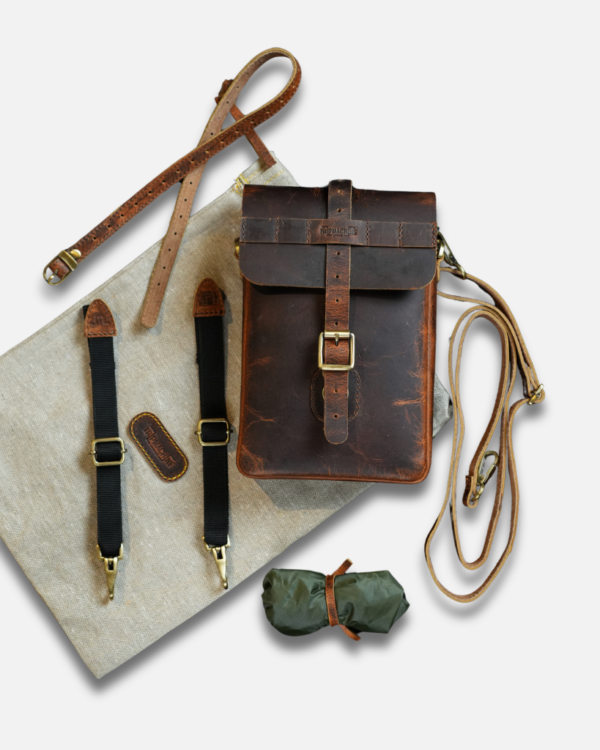Premium leather sling bag with quick-release mounting (motorcycle compatible), one-click opening, and included rain cover. Handcrafted and built to last, developing a unique patina over time. Perfect for everyday carry and more.