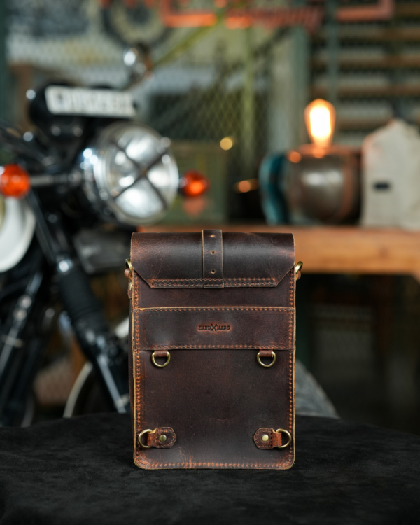 Premium leather sling bag with quick-release mounting (motorcycle compatible), one-click opening, and included rain cover. Handcrafted and built to last, developing a unique patina over time. Perfect for everyday carry and more.