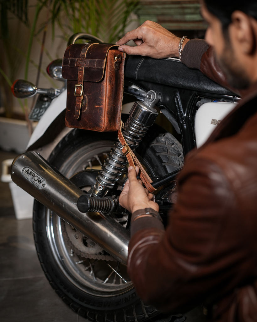 Premium leather sling bag with quick-release mounting (motorcycle compatible), one-click opening, and included rain cover. Handcrafted and built to last, developing a unique patina over time. Perfect for everyday carry and more.