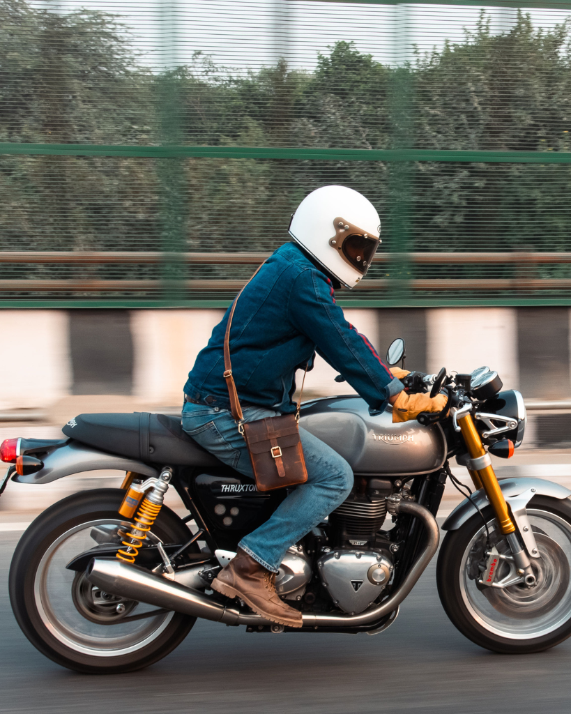 Premium leather sling bag with quick-release mounting (motorcycle compatible), one-click opening, and included rain cover. Handcrafted and built to last, developing a unique patina over time. Perfect for everyday carry and more.