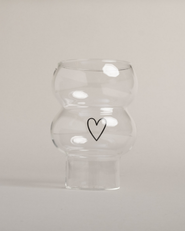 Add a touch of love to your drinks with the Double Bubble Heart Glass. This unique glass features a playful double bubble design and sweet heart accent, perfect for any beverage. Durable, dishwasher safe, and a great gift idea!