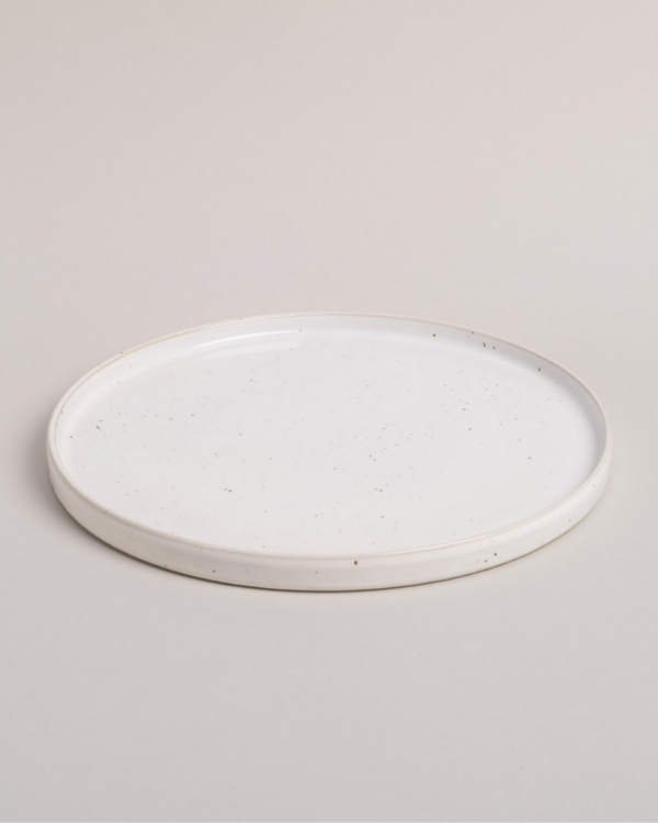 Elevate your dining experience with our handcrafted Calma dinner plate. Each 27cm plate features natural glaze variations and improved stackable design. Perfectly sized for main courses, this dishwasher-safe plate combines artisanal beauty with modern practicality.
