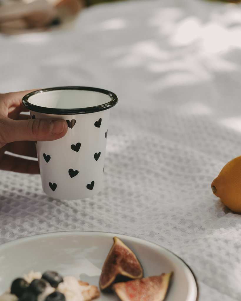Heart Pattern Enamel Camping Mug | 290ml | Outdoor & Camping Essential Add joy to your outdoor adventures with this charming enamel mug featuring delicate black hearts. Built tough for camping and picnics, this 290ml mug combines vintage style with modern durability. Dishwasher safe and easy to clean, it's perfect for hot drinks around the campfire or backyard gatherings. The sturdy enamel construction ensures long-lasting use while its compact size (9cm x 8.6cm) makes it ideal for camping kits and outdoor dining.