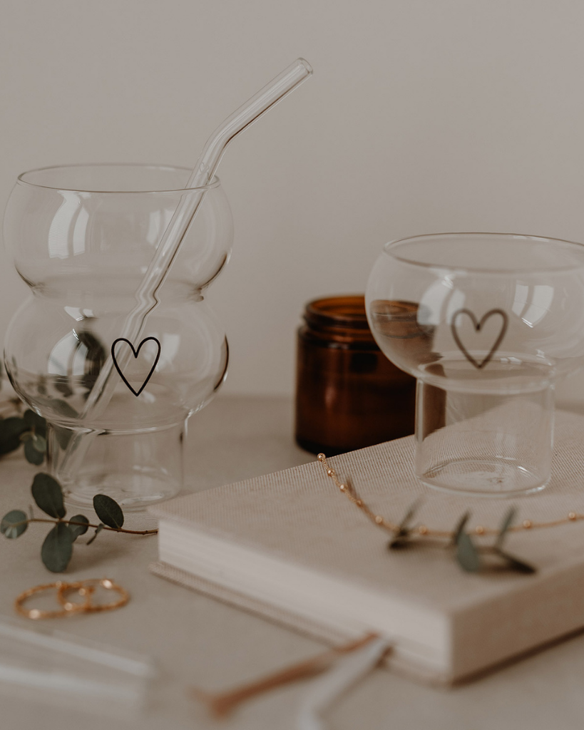 Add a touch of love to your drinks with the Double Bubble Heart Glass. This unique glass features a playful double bubble design and sweet heart accent, perfect for any beverage. Durable, dishwasher safe, and a great gift idea!
