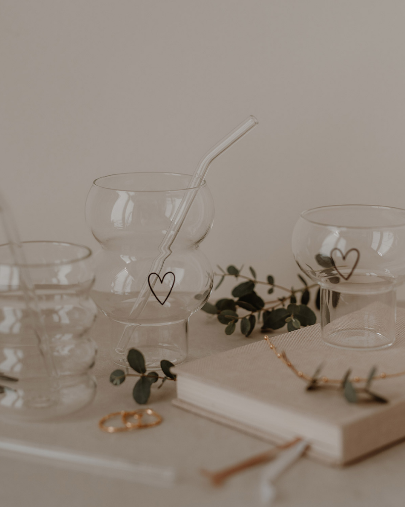 Add a touch of love to your drinks with the Double Bubble Heart Glass. This unique glass features a playful double bubble design and sweet heart accent, perfect for any beverage. Durable, dishwasher safe, and a great gift idea!