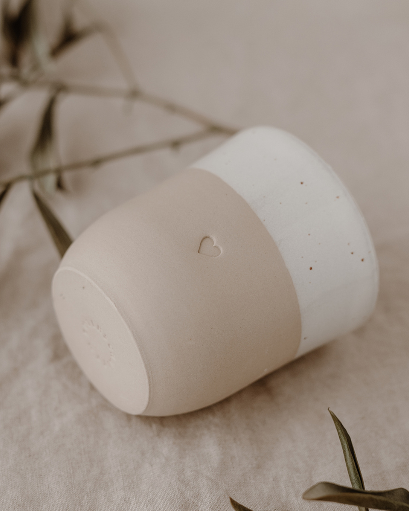 Discover the charm of handmade pottery with our exclusive stoneware heart mug. Each 320ml mug is carefully crafted in a small Portuguese pottery, featuring a beautiful embossed heart design. Every piece is unique, showcasing subtle variations in glaze and texture that make it truly special. Combining practicality with artisanal beauty, these dishwasher-safe mugs measure 8.5-9cm in height, perfect for your daily coffee or tea ritual.