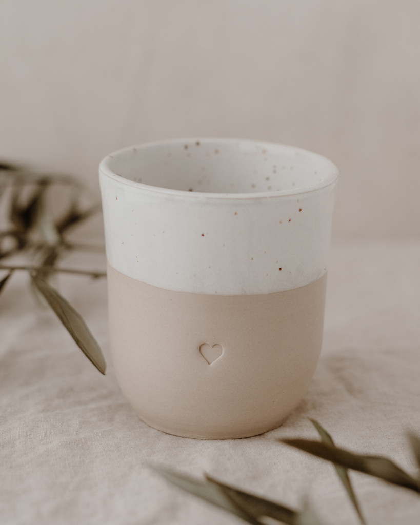 Discover the charm of handmade pottery with our exclusive stoneware heart mug. Each 320ml mug is carefully crafted in a small Portuguese pottery, featuring a beautiful embossed heart design. Every piece is unique, showcasing subtle variations in glaze and texture that make it truly special. Combining practicality with artisanal beauty, these dishwasher-safe mugs measure 8.5-9cm in height, perfect for your daily coffee or tea ritual.