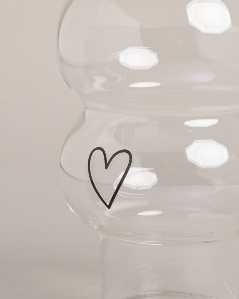 Add a touch of love to your drinks with the Double Bubble Heart Glass. This unique glass features a playful double bubble design and sweet heart accent, perfect for any beverage. Durable, dishwasher safe, and a great gift idea!