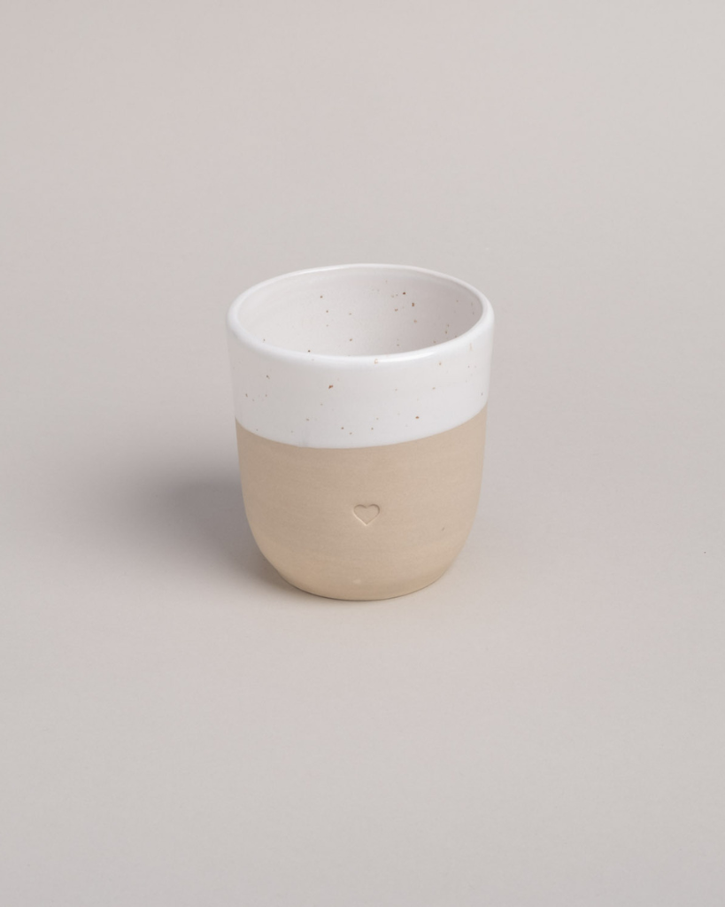 Discover the charm of handmade pottery with our exclusive stoneware heart mug. Each 320ml mug is carefully crafted in a small Portuguese pottery, featuring a beautiful embossed heart design. Every piece is unique, showcasing subtle variations in glaze and texture that make it truly special. Combining practicality with artisanal beauty, these dishwasher-safe mugs measure 8.5-9cm in height, perfect for your daily coffee or tea ritual.