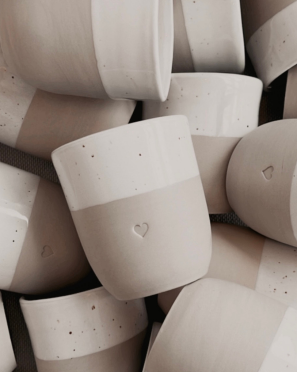 Discover the charm of handmade pottery with our exclusive stoneware heart mug. Each 320ml mug is carefully crafted in a small Portuguese pottery, featuring a beautiful embossed heart design. Every piece is unique, showcasing subtle variations in glaze and texture that make it truly special. Combining practicality with artisanal beauty, these dishwasher-safe mugs measure 8.5-9cm in height, perfect for your daily coffee or tea ritual.