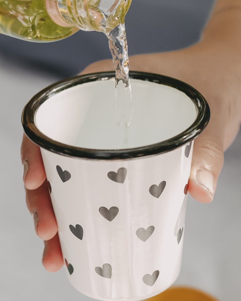 Heart Pattern Enamel Camping Mug | 290ml | Outdoor & Camping Essential Add joy to your outdoor adventures with this charming enamel mug featuring delicate black hearts. Built tough for camping and picnics, this 290ml mug combines vintage style with modern durability. Dishwasher safe and easy to clean, it's perfect for hot drinks around the campfire or backyard gatherings. The sturdy enamel construction ensures long-lasting use while its compact size (9cm x 8.6cm) makes it ideal for camping kits and outdoor dining.