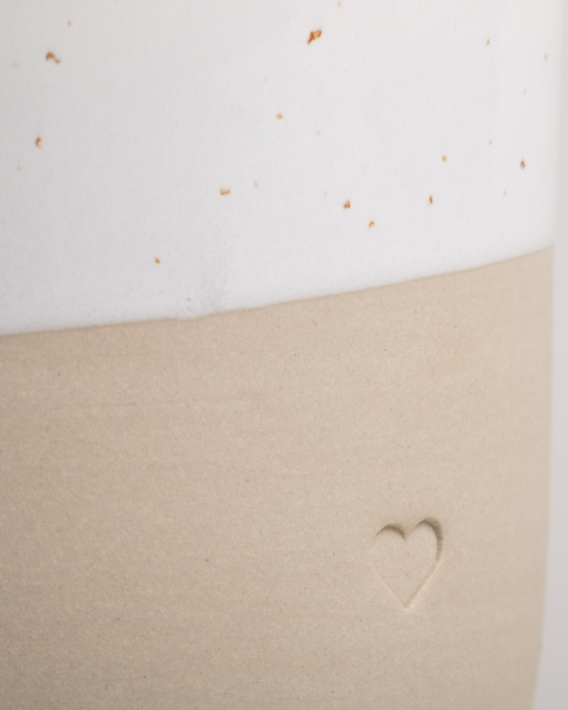 Discover the charm of handmade pottery with our exclusive stoneware heart mug. Each 320ml mug is carefully crafted in a small Portuguese pottery, featuring a beautiful embossed heart design. Every piece is unique, showcasing subtle variations in glaze and texture that make it truly special. Combining practicality with artisanal beauty, these dishwasher-safe mugs measure 8.5-9cm in height, perfect for your daily coffee or tea ritual.