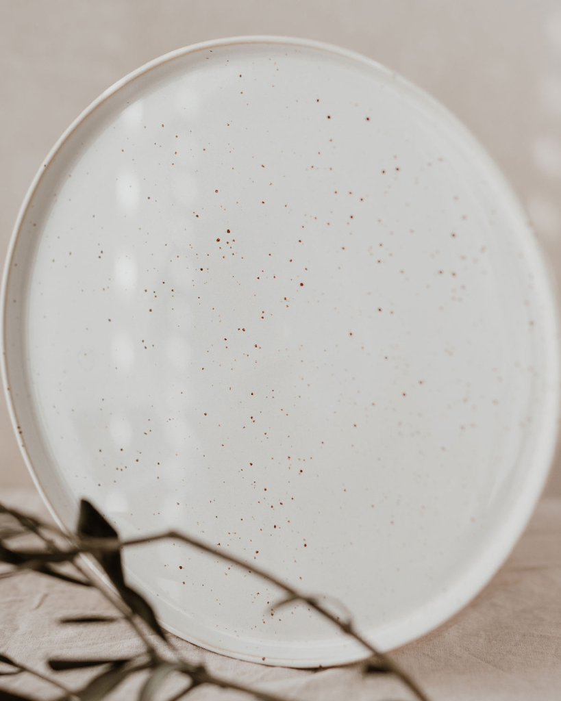 Elevate your dining experience with our handcrafted Calma dinner plate. Each 27cm plate features natural glaze variations and improved stackable design. Perfectly sized for main courses, this dishwasher-safe plate combines artisanal beauty with modern practicality.