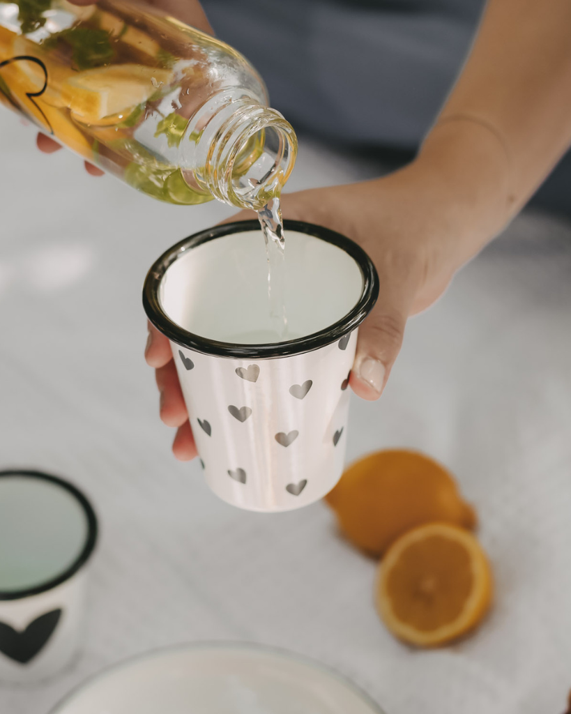 Heart Pattern Enamel Camping Mug | 290ml | Outdoor & Camping Essential Add joy to your outdoor adventures with this charming enamel mug featuring delicate black hearts. Built tough for camping and picnics, this 290ml mug combines vintage style with modern durability. Dishwasher safe and easy to clean, it's perfect for hot drinks around the campfire or backyard gatherings. The sturdy enamel construction ensures long-lasting use while its compact size (9cm x 8.6cm) makes it ideal for camping kits and outdoor dining.