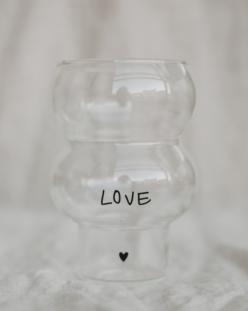 Celebrate love with our Double Bubble glass featuring elegant "Love" lettering and heart detail. This 450ml glass combines style with sentiment, perfect for special occasions or adding romance to everyday moments. Standing elegantly at 12.8cm tall with an 8.9cm width, it's perfectly sized for everything from refreshing cocktails to creative desserts. Dishwasher safe.