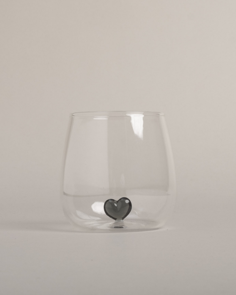Elevate your drinkware with this unique black heart drinking glass. Featuring a striking 3D black heart design floating inside a high-quality glass, this piece adds a touch of elegance to any occasion. Perfect for everyday use or special gatherings, this glass is both beautiful and practical.