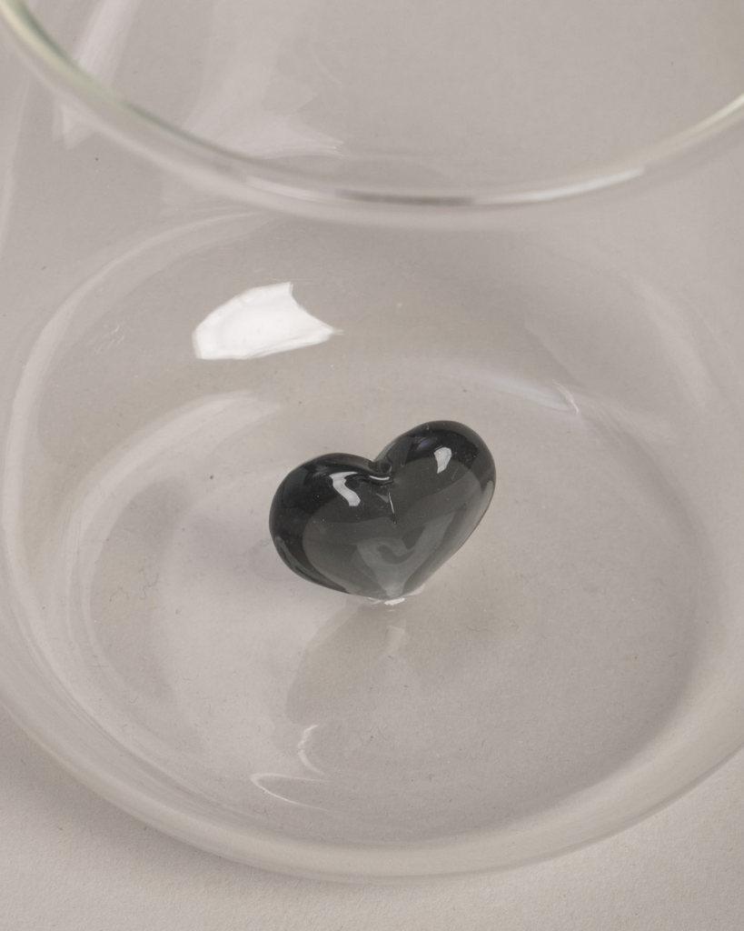 Elevate your drinkware with this unique black heart drinking glass. Featuring a striking 3D black heart design floating inside a high-quality glass, this piece adds a touch of elegance to any occasion. Perfect for everyday use or special gatherings, this glass is both beautiful and practical.