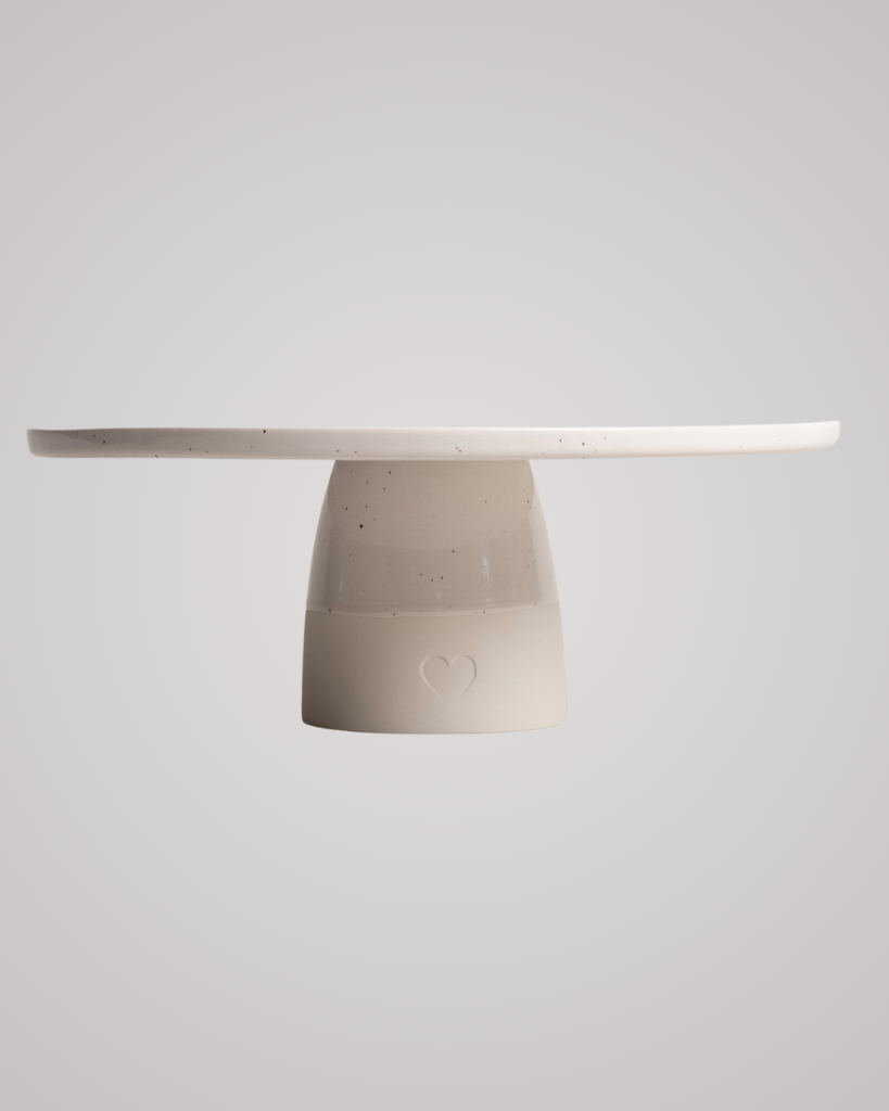 Showcase your cakes beautifully with our handmade Calma stoneware cake stand, now in 7cm and 10cm heights. Featuring a 28cm diameter, unique glaze, and easy-to-clean surface, it's perfect for celebrations and stylish decoration. Use both sizes together for a tiered display!