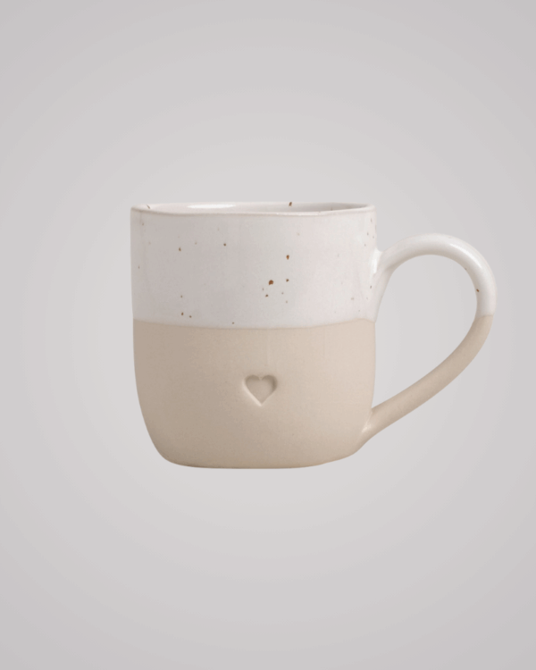 Discover your perfect cappuccino cup! Our handmade stoneware mug features a signature blind embossed heart design and ideal capacity for your favorite coffees. Dishwasher and microwave safe. Capacity: 150 ml (usable), 190 ml (full).