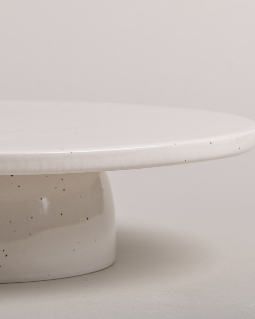 Showcase your cakes beautifully with our handmade Calma stoneware cake stand, now in 7cm and 10cm heights. Featuring a 28cm diameter, unique glaze, and easy-to-clean surface, it's perfect for celebrations and stylish decoration. Use both sizes together for a tiered display!