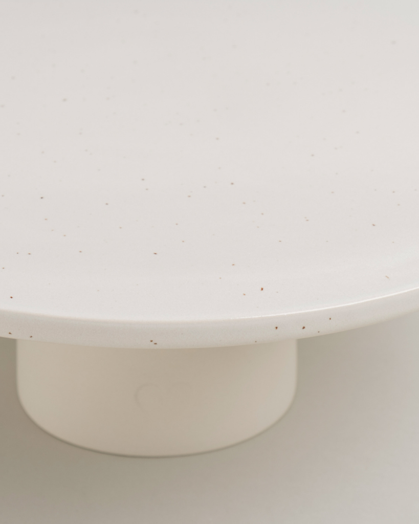 Showcase your cakes beautifully with our handmade Calma stoneware cake stand, now in 7cm and 10cm heights. Featuring a 28cm diameter, unique glaze, and easy-to-clean surface, it's perfect for celebrations and stylish decoration. Use both sizes together for a tiered display!