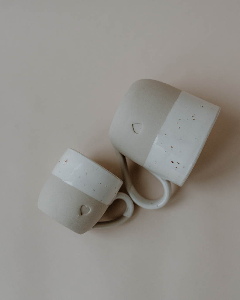 Discover your perfect cappuccino cup! Our handmade stoneware mug features a signature blind embossed heart design and ideal capacity for your favorite coffees. Dishwasher and microwave safe. Capacity: 150 ml (usable), 190 ml (full).