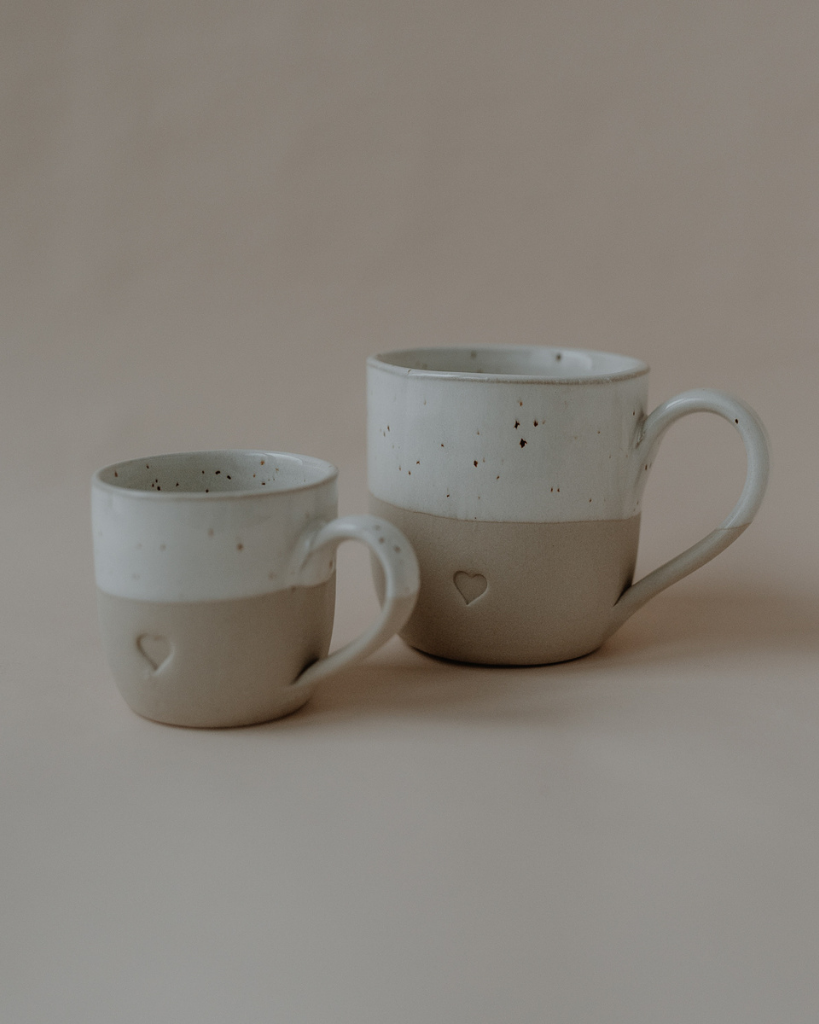 Discover your perfect cappuccino cup! Our handmade stoneware mug features a signature blind embossed heart design and ideal capacity for your favorite coffees. Dishwasher and microwave safe. Capacity: 150 ml (usable), 190 ml (full).