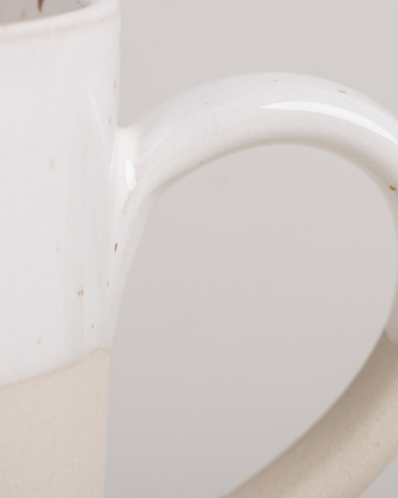 Discover your perfect cappuccino cup! Our handmade stoneware mug features a signature blind embossed heart design and ideal capacity for your favorite coffees. Dishwasher and microwave safe. Capacity: 150 ml (usable), 190 ml (full).