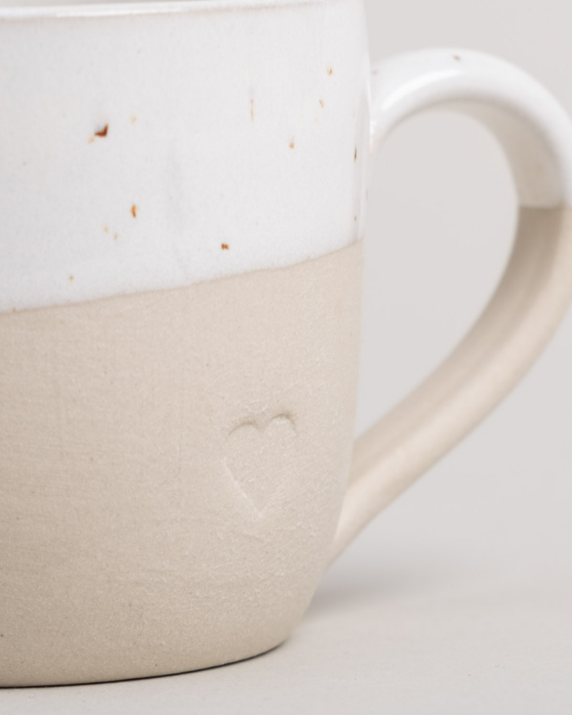 Sip with love from our handcrafted espresso cup featuring a subtle blind embossed heart design and practical handle. Unique stoneware charm. Dishwasher and microwave safe. Capacity: 60 ml (usable), 80 ml (full).
