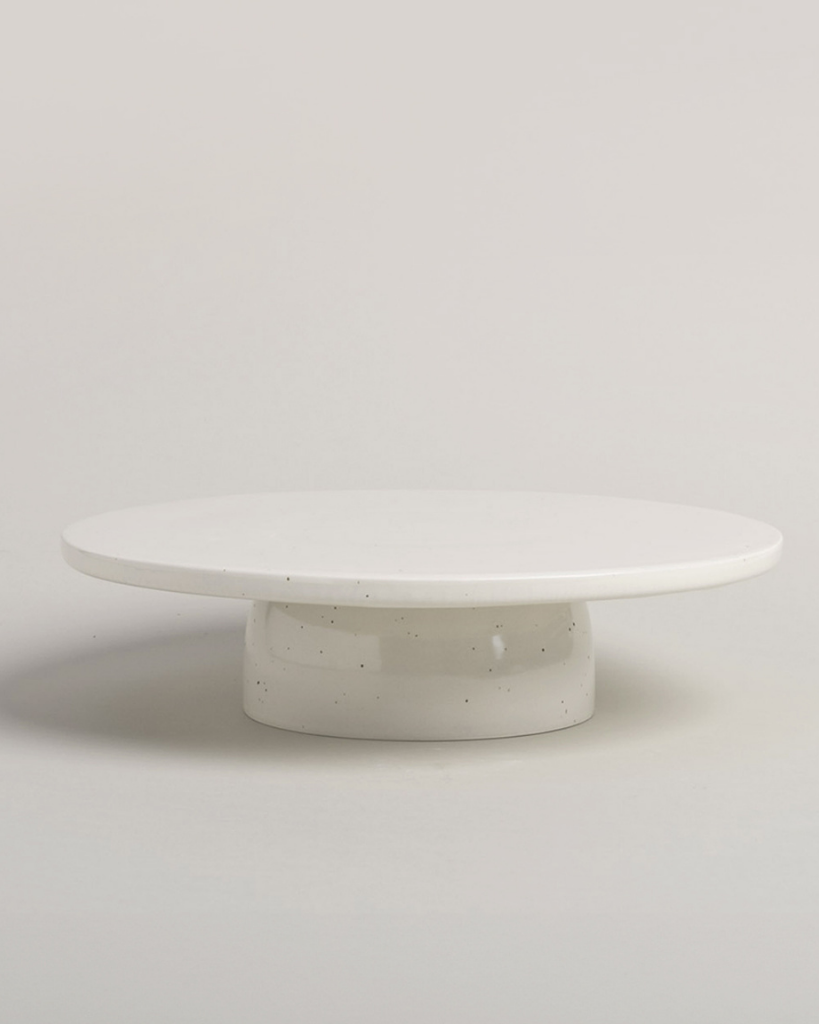 Showcase your cakes beautifully with our handmade Calma stoneware cake stand, now in 7cm and 10cm heights. Featuring a 28cm diameter, unique glaze, and easy-to-clean surface, it's perfect for celebrations and stylish decoration. Use both sizes together for a tiered display!