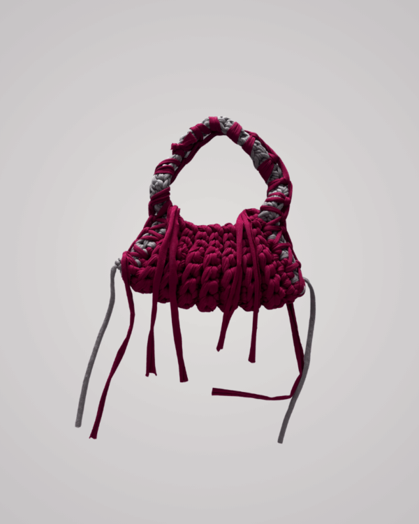 This handcrafted maroon crochet bag combines style and function. Made from soft t-shirt yarn, it easily transitions from shoulder to handbag.