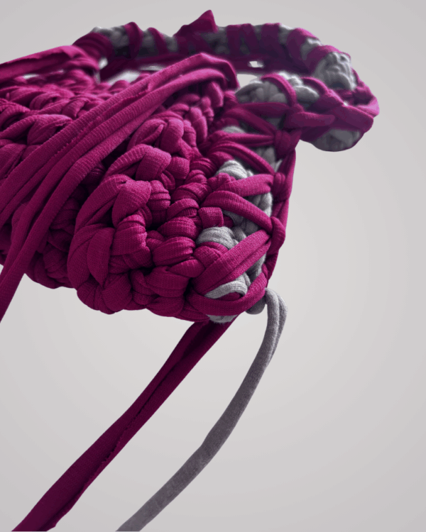This handcrafted maroon crochet bag combines style and function. Made from soft t-shirt yarn, it easily transitions from shoulder to handbag.
