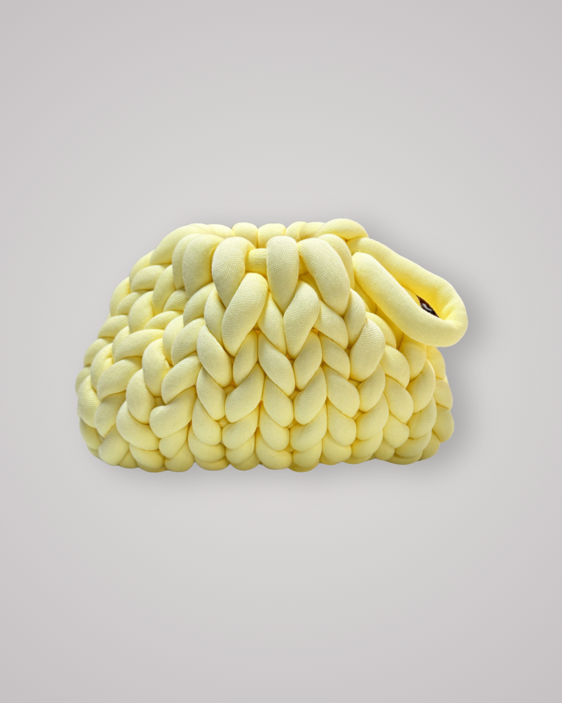 Hand-crocheted chunky yarn bag in a soft butter yellow colour